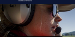 Young women student pilot in cockpit of private plane with headphones, sunglasses, and a mic. Copy reads: LU Online, Liberty University, Bachelor of Science in Aviation